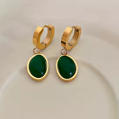 Stainless steel dangle earrings with emeralds