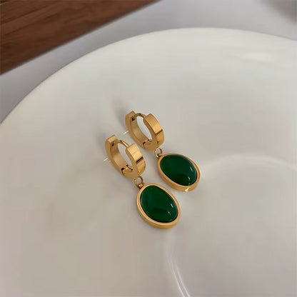 Stainless steel dangle earrings with emeralds
