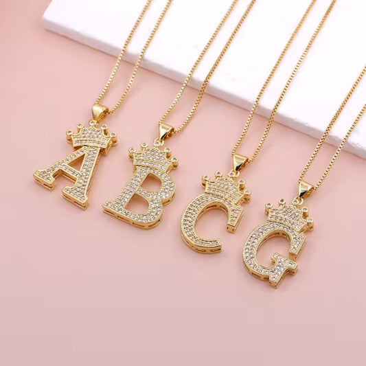 Necklace with English crown letter pendant and white cubic zirconia.